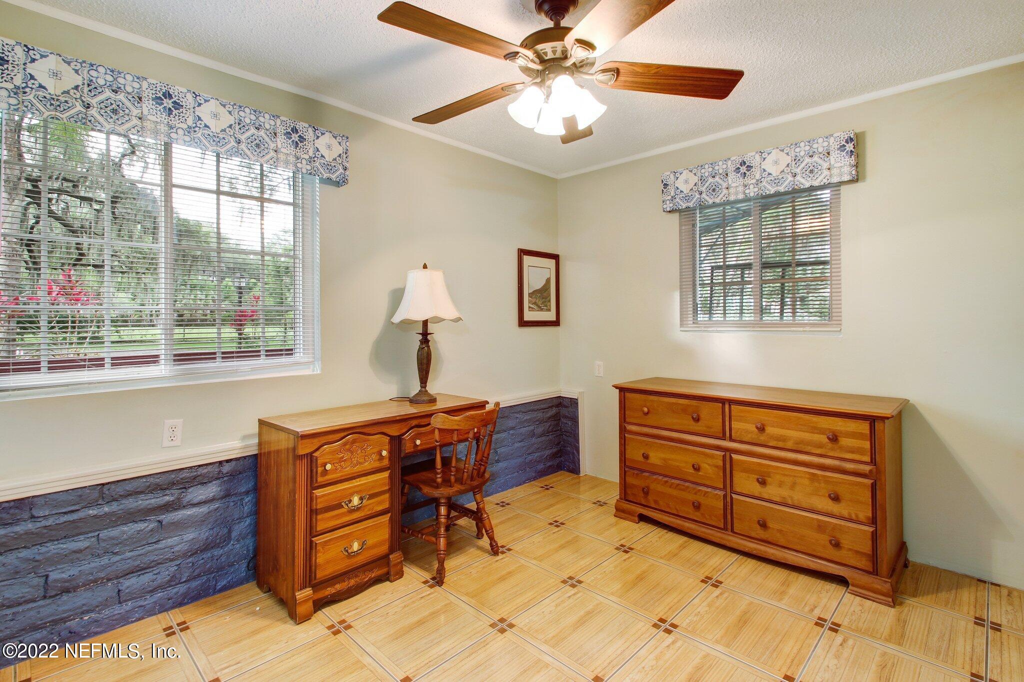 101 Orange Street Satsuma, FL 32189 - Photo 40 of 67 a bed room with a bed and a chandelier