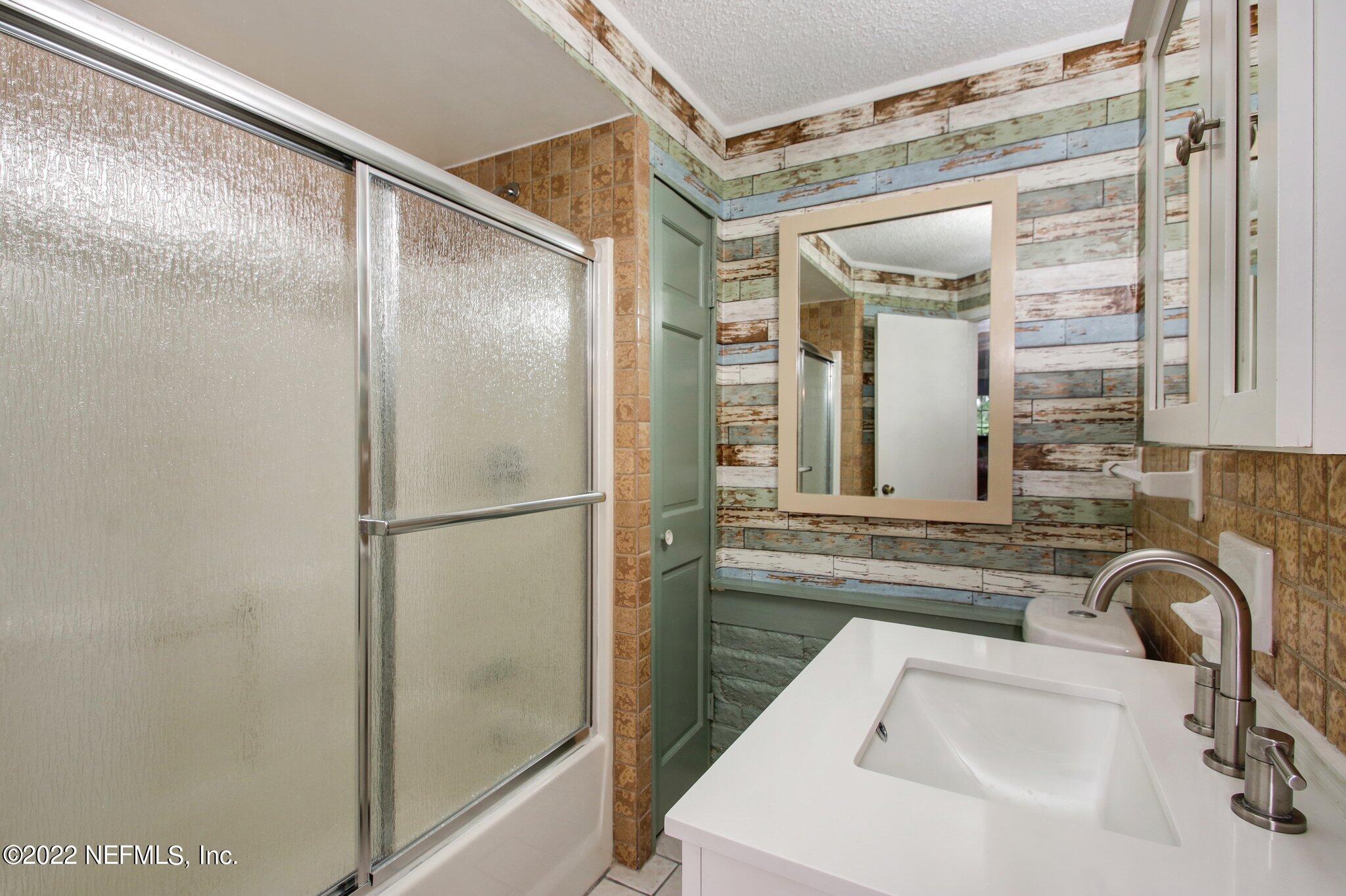 101 Orange Street Satsuma, FL 32189 - Photo 42 of 67 a bathroom with a sink and a mirror