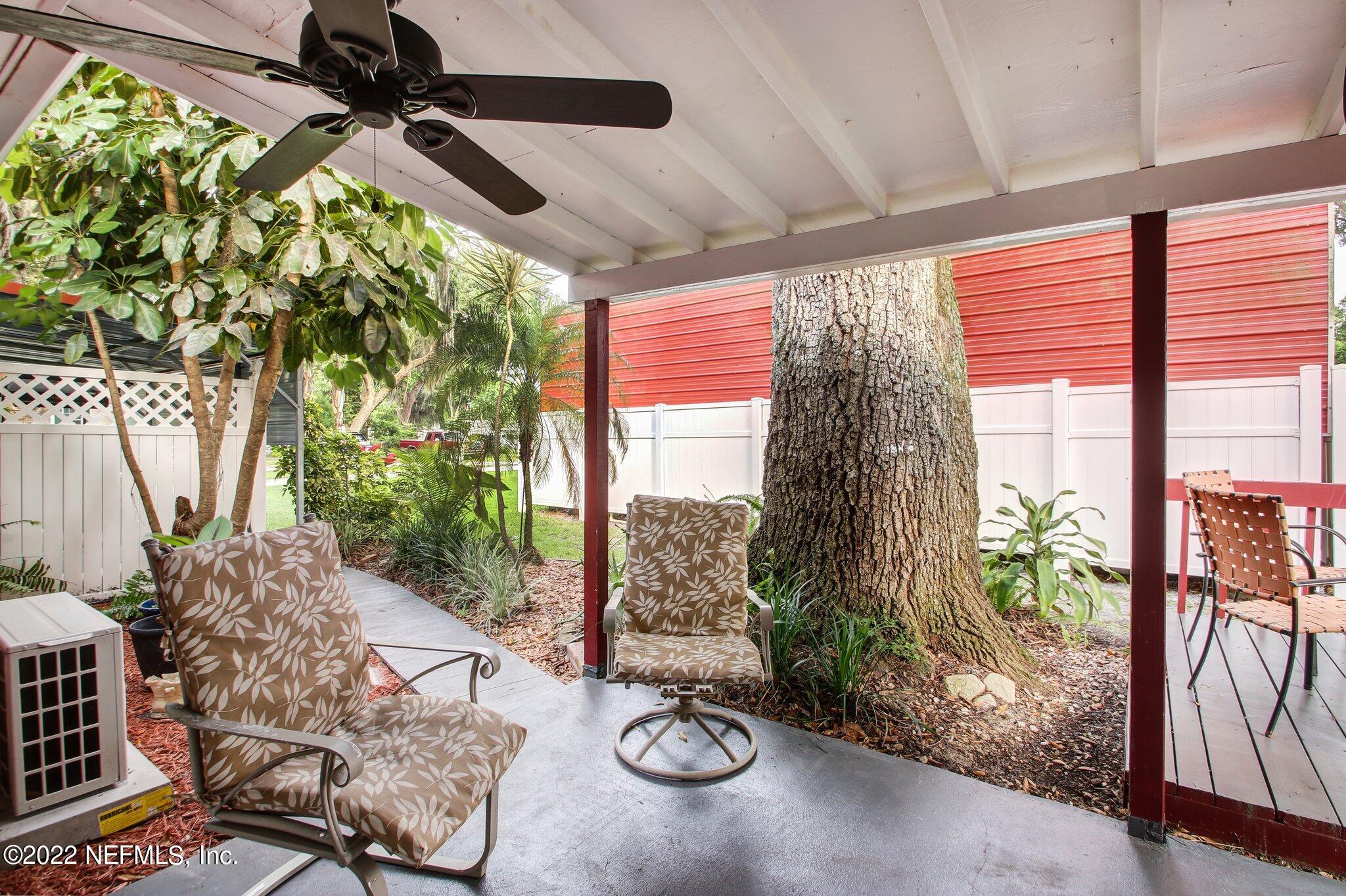 101 Orange Street Satsuma, FL 32189 - Photo 44 of 67 a view of a porch with furniture and a yard