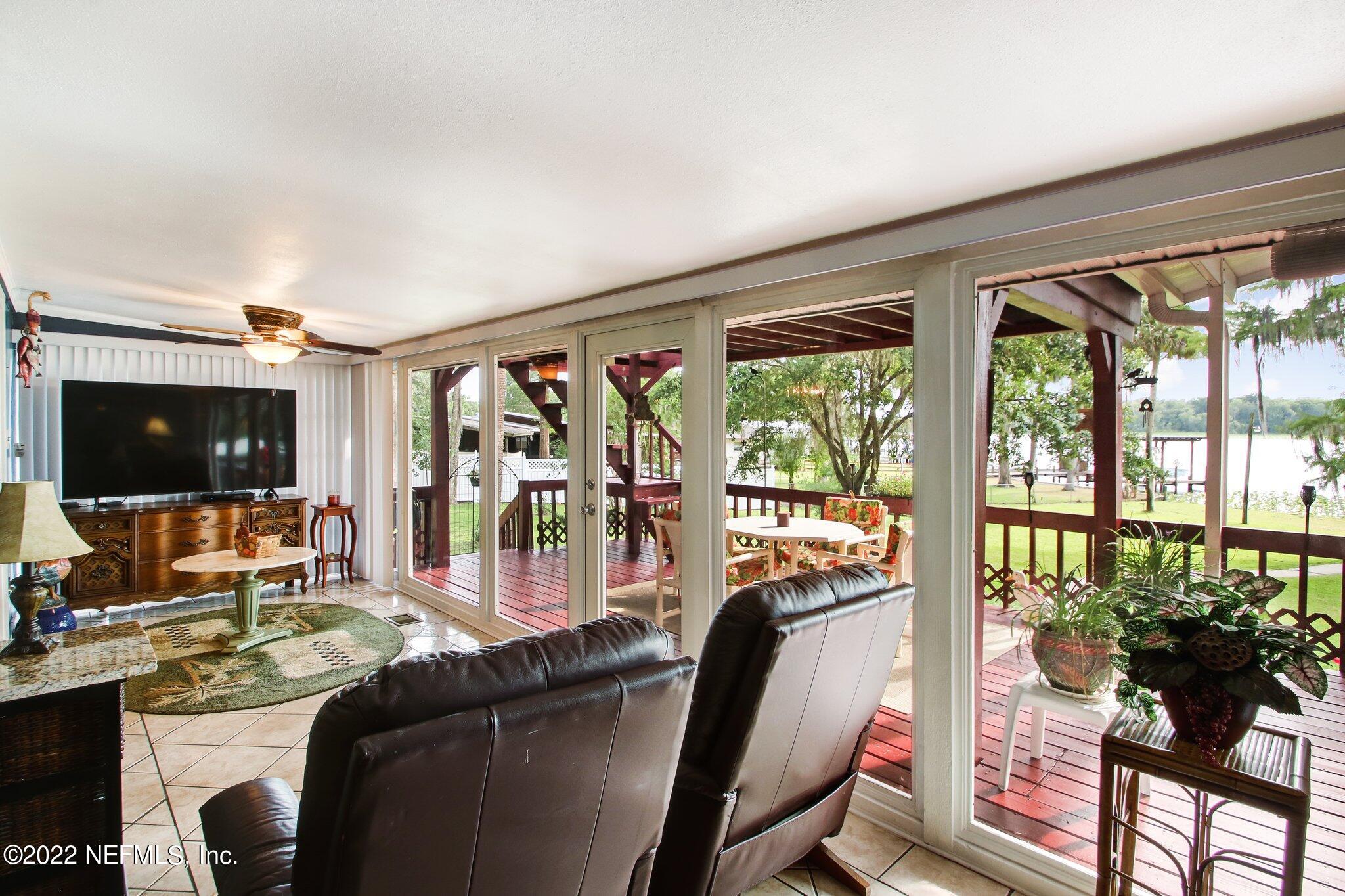 101 Orange Street Satsuma, FL 32189 - Photo 9 of 67 a living room with furniture tv and large window