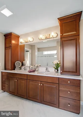 a bathroom with a granite countertop sink and a mirror