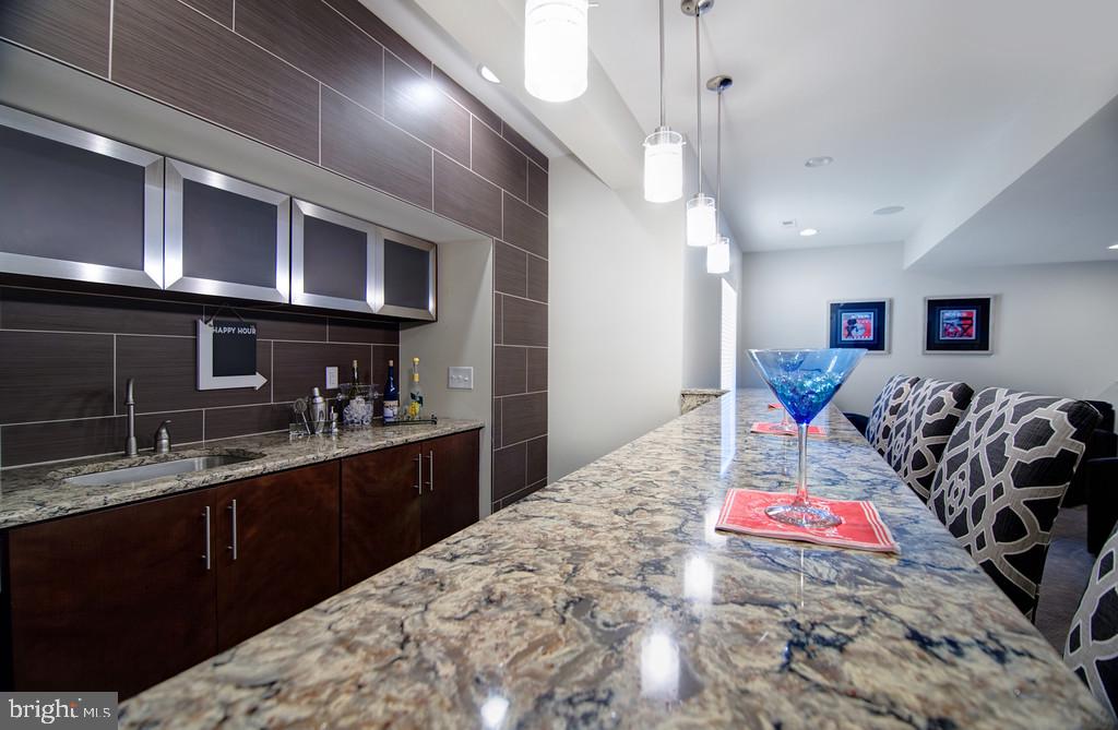 400 Rederick Lane, Unit 1 Middletown, DE 19709 - Photo 34 of 39 a kitchen with stainless steel appliances kitchen island granite countertop a sink cabinets and wooden floor