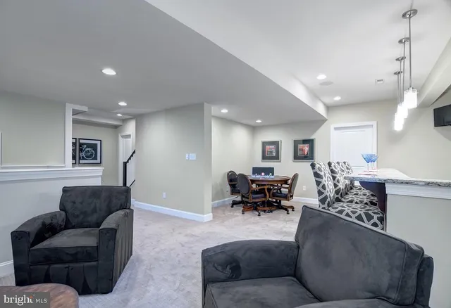 a living room with furniture and a piano