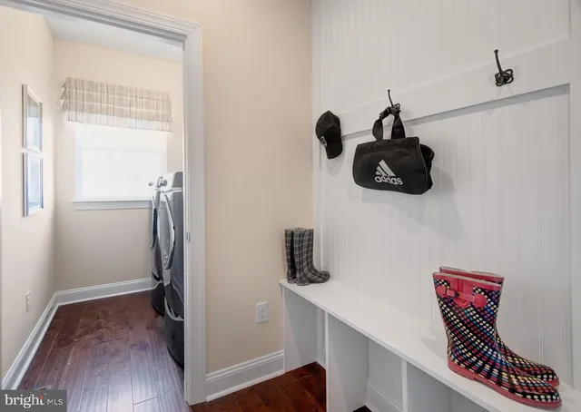 a view of entryway and hall with wooden floor