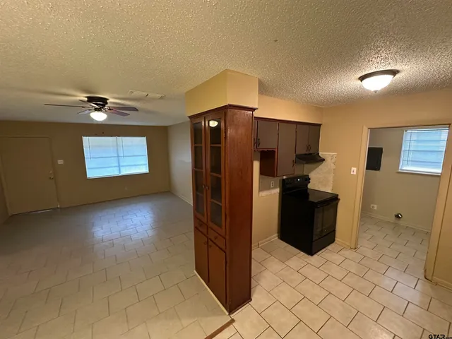 a kitchen with stainless steel appliances a refrigerator and a stove