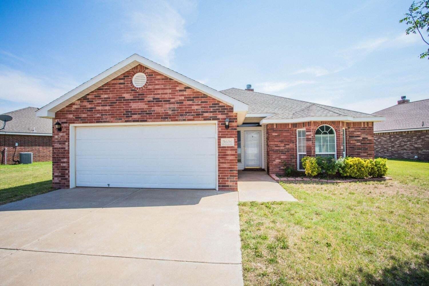 3606 Pontiac Avenue Lubbock, TX 79407 - Photo 1 of 17 a front view of a house with a yard and garage