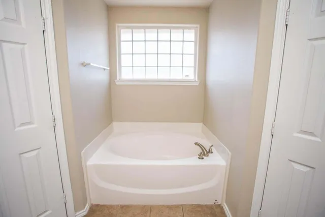 a white bath tub sitting in a bathroom