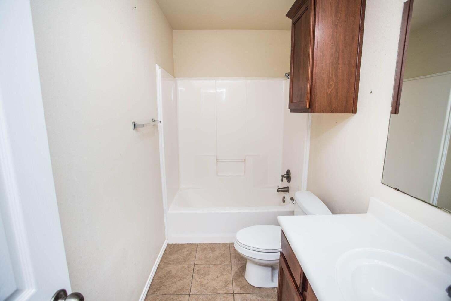3606 Pontiac Avenue Lubbock, TX 79407 - Photo 13 of 17 a bathroom with a toilet and a shower