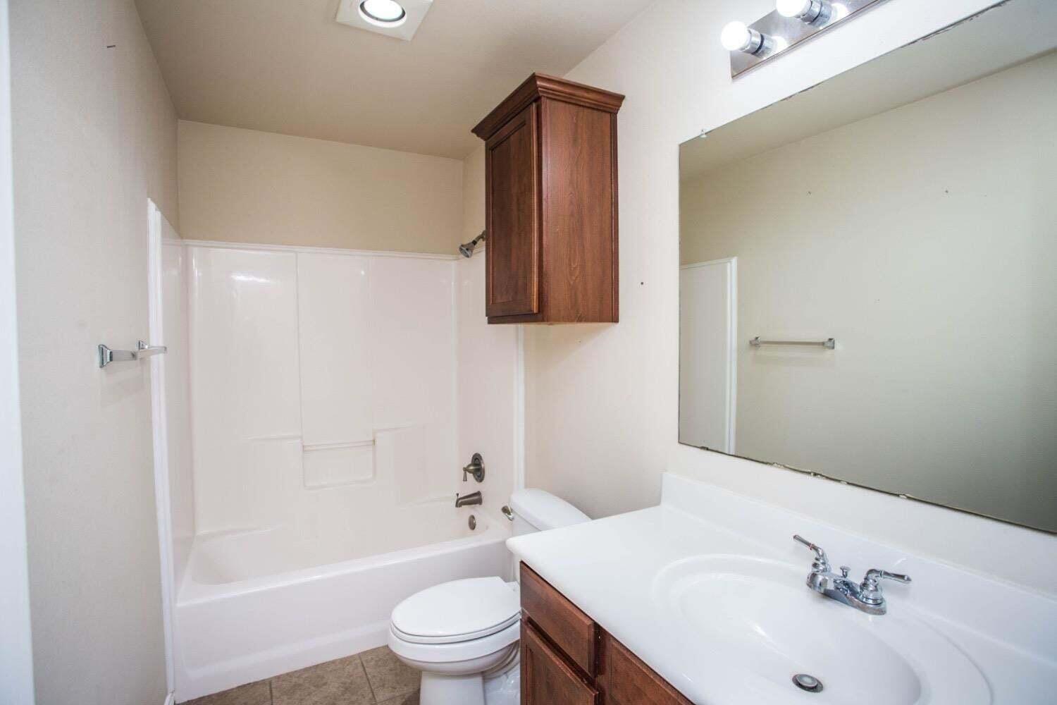 3606 Pontiac Avenue Lubbock, TX 79407 - Photo 14 of 17 a bathroom with a sink toilet and shower