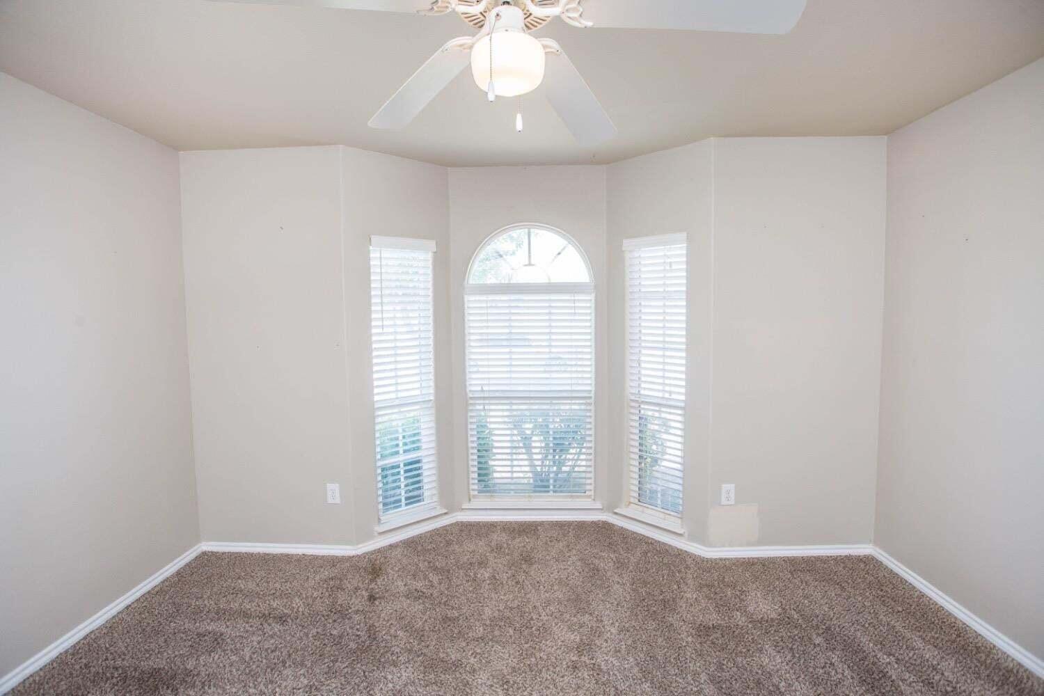 3606 Pontiac Avenue Lubbock, TX 79407 - Photo 15 of 17 an empty room with a window and a chandelier