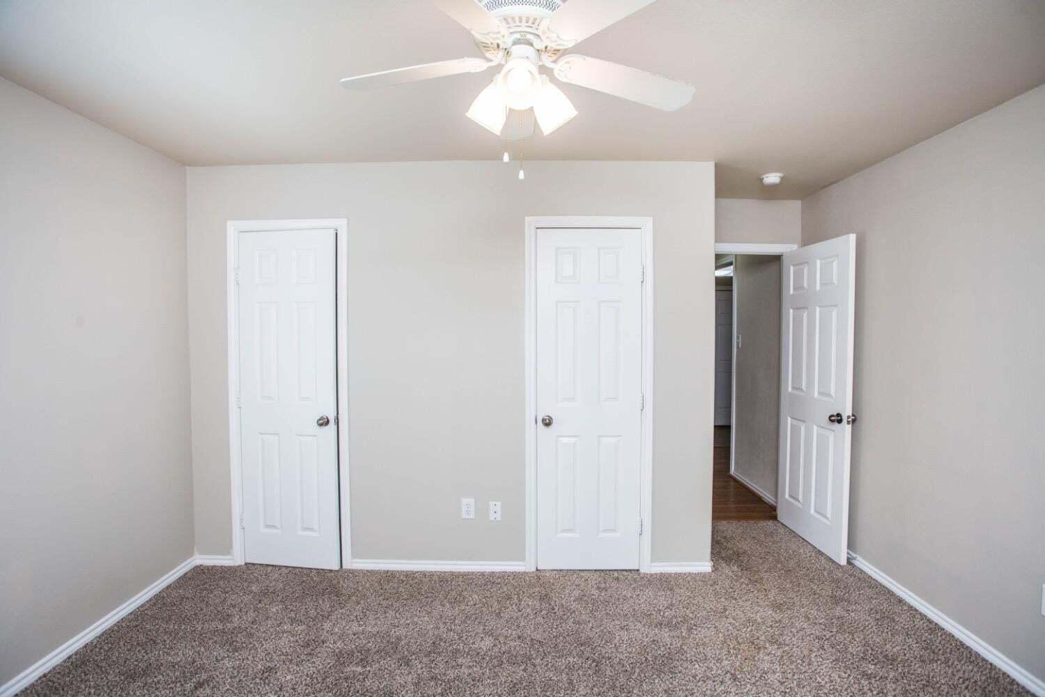 3606 Pontiac Avenue Lubbock, TX 79407 - Photo 17 of 17 an empty room with closet and a chandelier fan