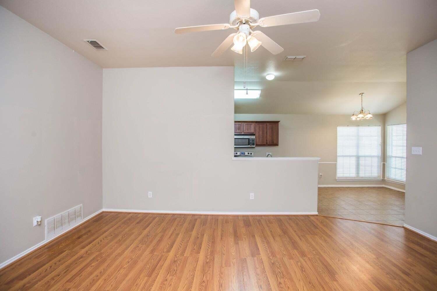 3606 Pontiac Avenue Lubbock, TX 79407 - Photo 3 of 17 wooden floor in an empty room with a window