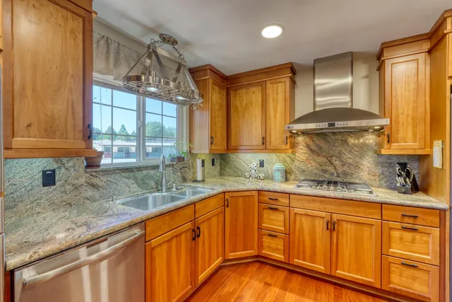 a living room with furniture a potted plant and a large window