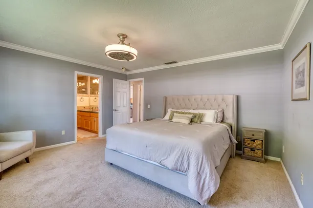 a bathroom with a granite countertop double vanity sink mirror and shower