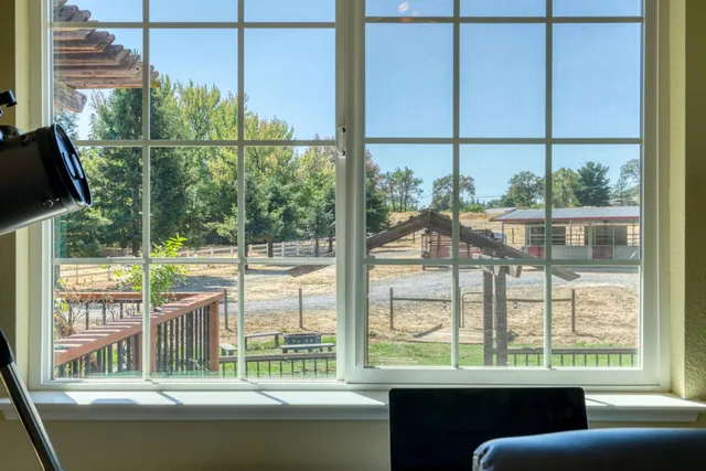 a view of a house with a yard and sitting area
