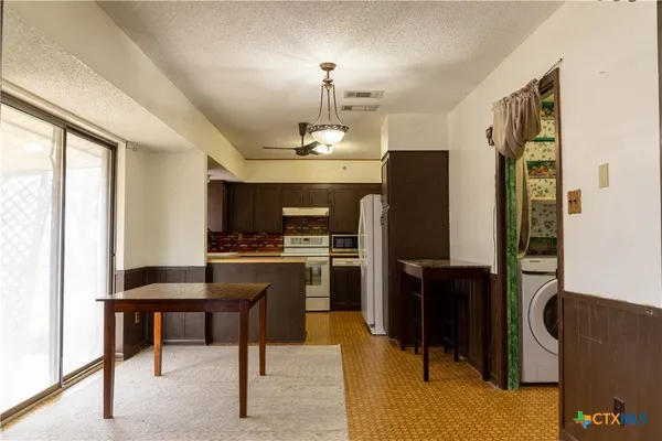 a kitchen with a sink stove and cabinets