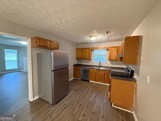 a kitchen with stainless steel appliances a refrigerator and a stove