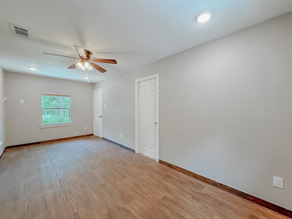 325 Fcr, Unit 1211 Fairfield, TX 75840 - Photo 11 of 28 an empty room with wooden floor and ceiling fan