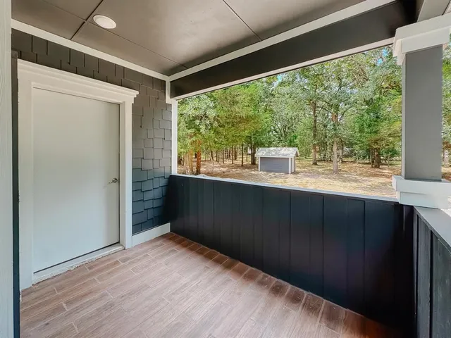 a kitchen with a window and wooden floor