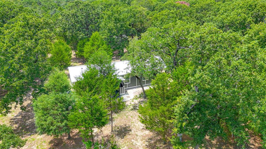 325 Fcr, Unit 1211 Fairfield, TX 75840 - Photo 24 of 28 a backyard of a house with lots of green space and trees all around