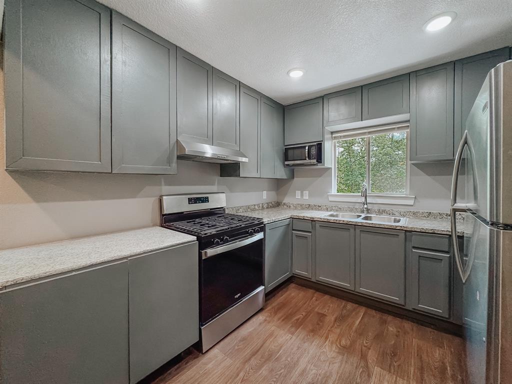 325 Fcr, Unit 1211 Fairfield, TX 75840 - Photo 5 of 28 a kitchen with granite countertop stainless steel appliances a stove sink and cabinets