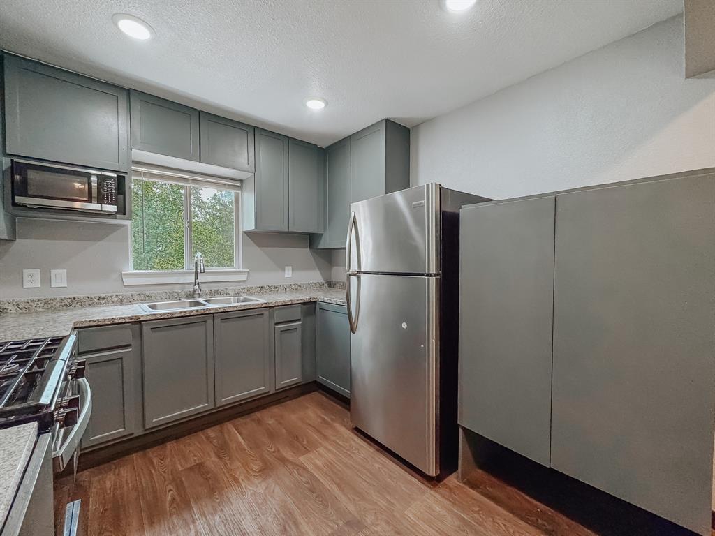 325 Fcr, Unit 1211 Fairfield, TX 75840 - Photo 6 of 28 a kitchen with a refrigerator and a sink