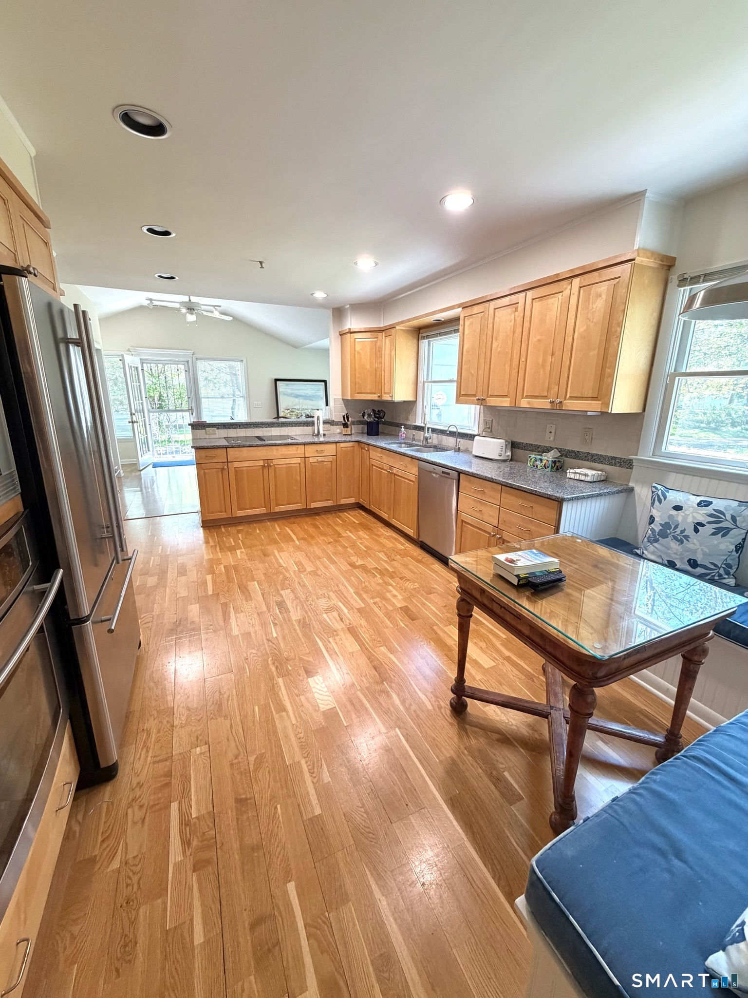 511 Roxbury Road Stamford, CT 06902 - Photo 4 of 19 a living room with kitchen island granite countertop wooden floors and a sink