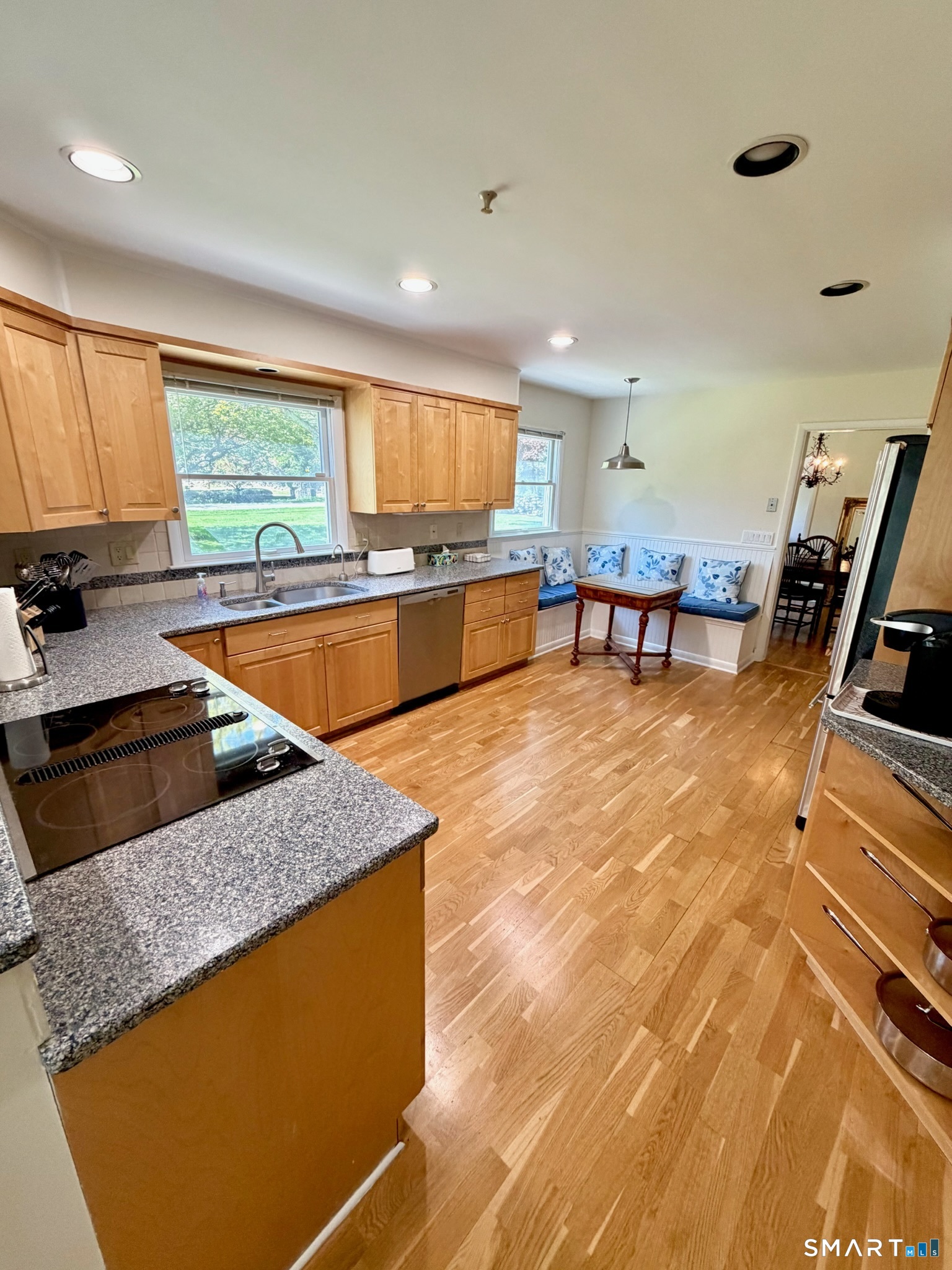 511 Roxbury Road Stamford, CT 06902 - Photo 5 of 19 a kitchen with stainless steel appliances granite countertop a sink a stove top oven a counter space and cabinets