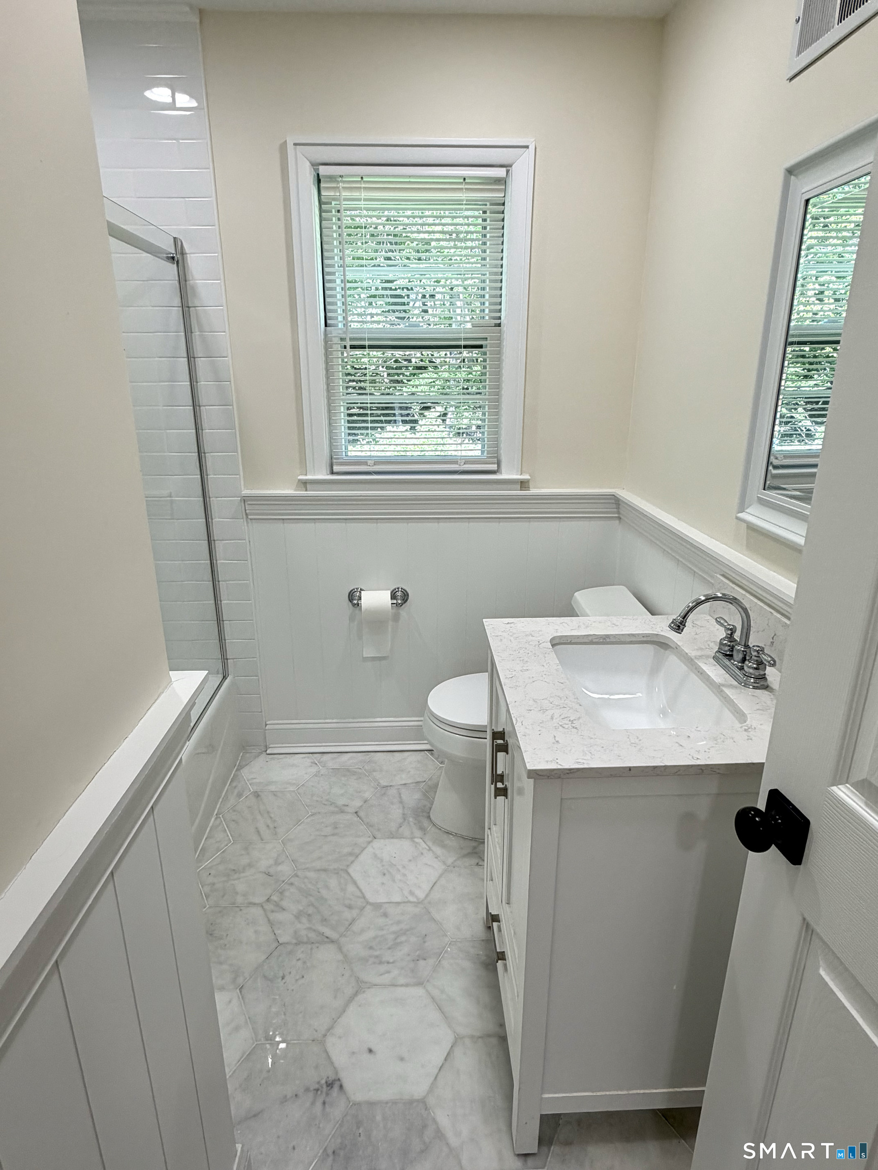 511 Roxbury Road Stamford, CT 06902 - Photo 10 of 19 a bathroom with a sink toilet and window