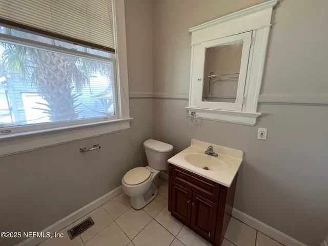 a bathroom with a sink toilet and mirror