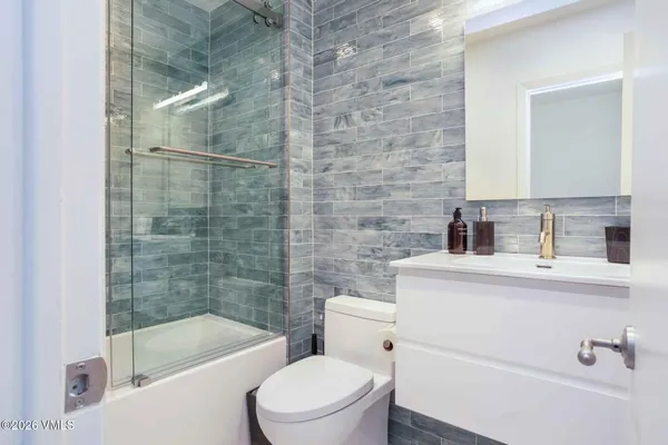 a bathroom with a sink a toilet and bathtub