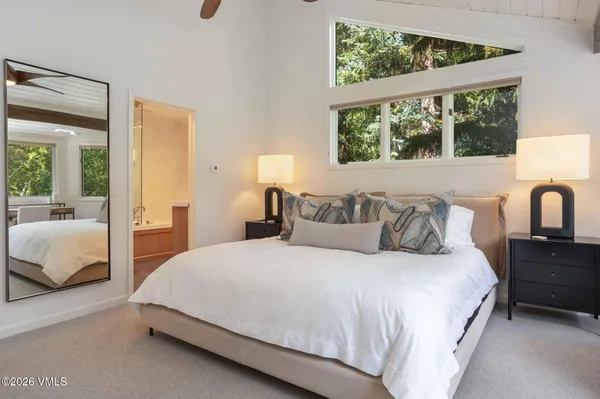 a bedroom with a large bed and a window
