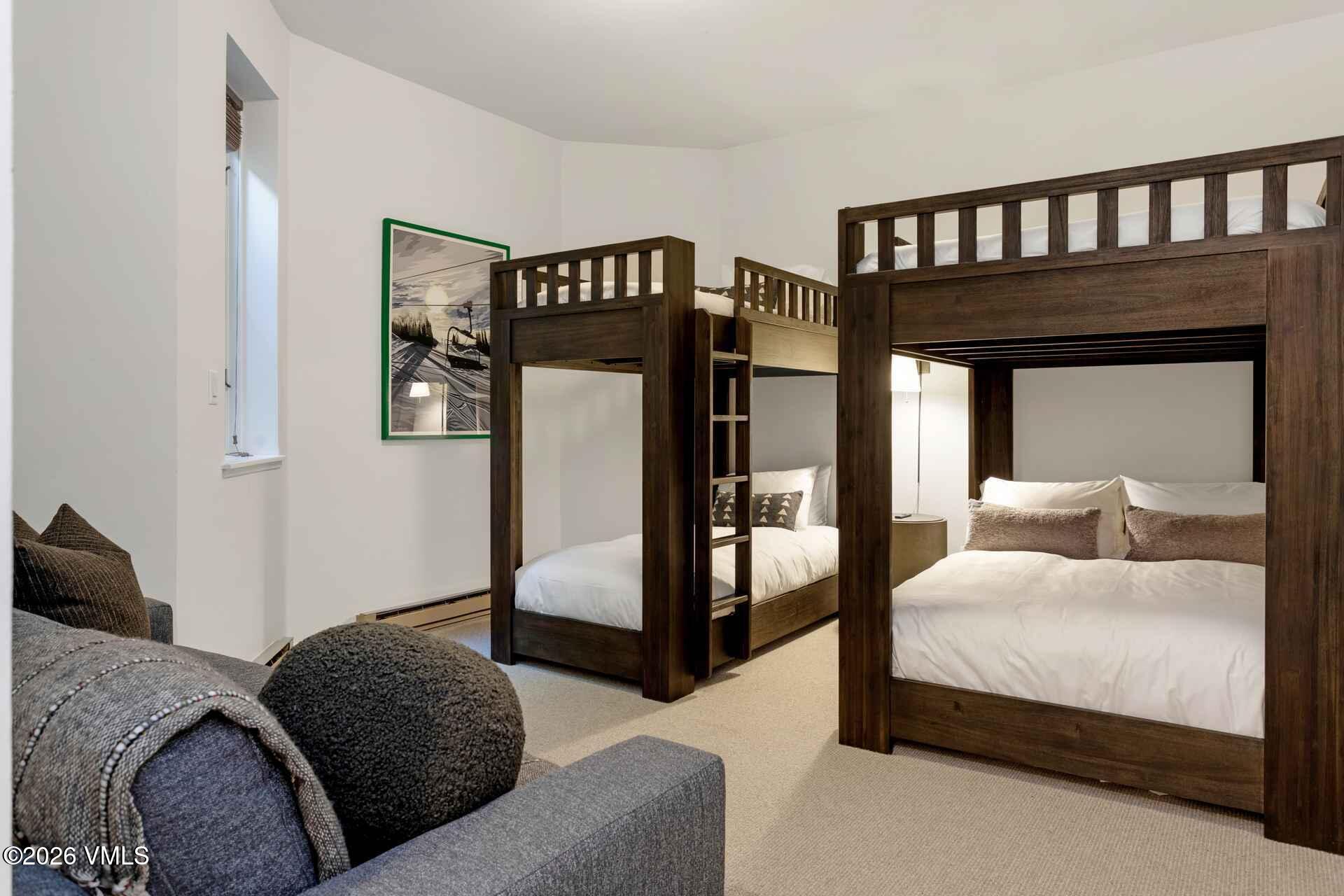 1592 Golf Terrace, Unit 55 Vail, CO 81657 - Photo 26 of 34 a bedroom with a bed couch and a window