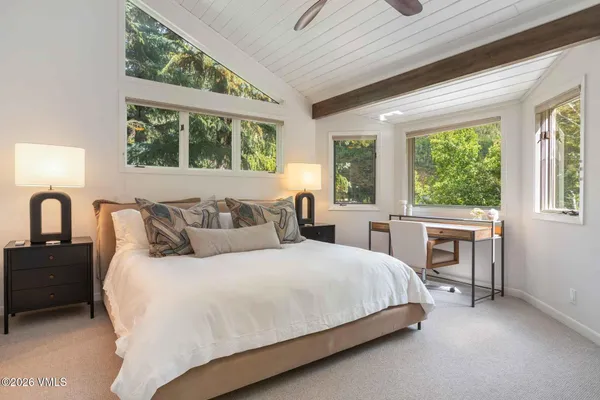 a bedroom with a large bed and a large window
