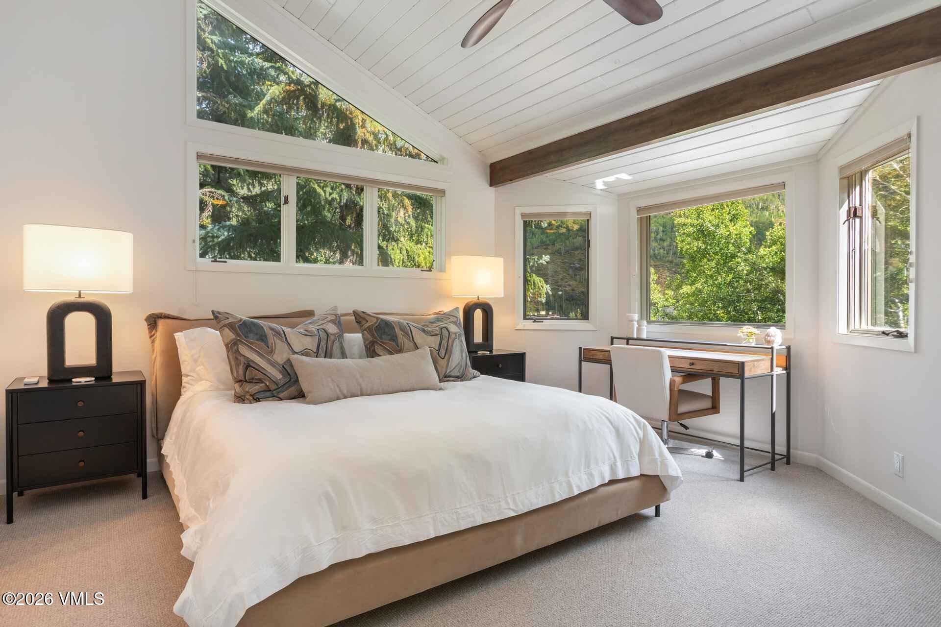 1592 Golf Terrace, Unit 55 Vail, CO 81657 - Photo 3 of 34 a bedroom with a large bed and a large window