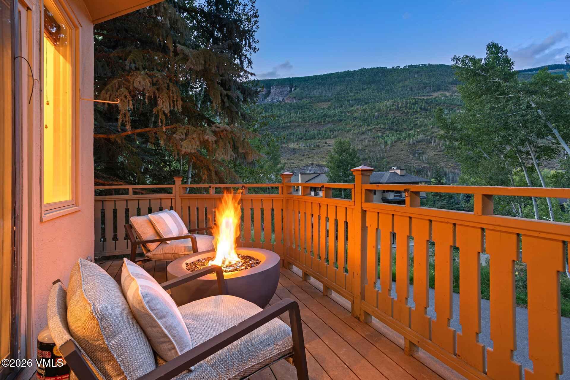 1592 Golf Terrace, Unit 55 Vail, CO 81657 - Photo 5 of 34 a blue bench sitting in front of a building