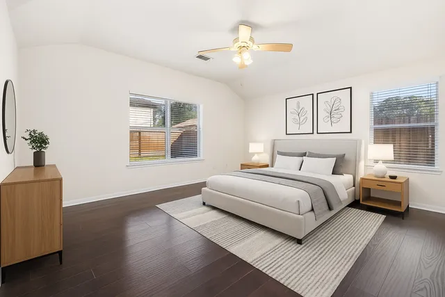 a bedroom with a bed and wooden floor