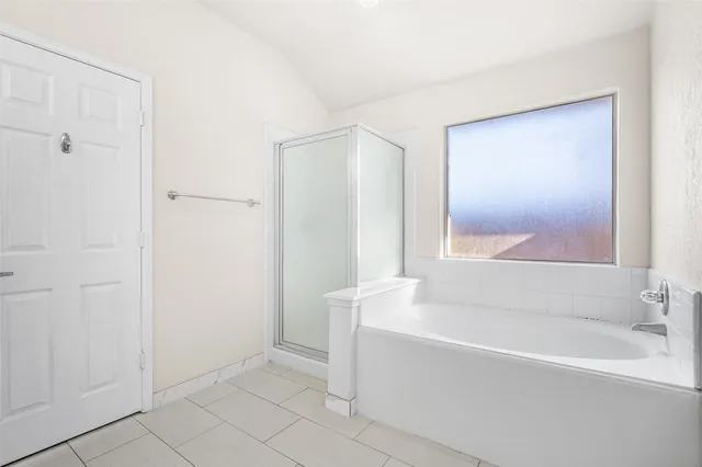 a white bath tub sitting next to a shower