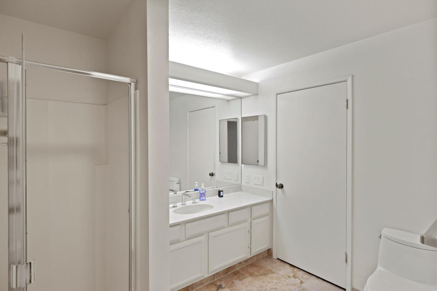 22 Shepherds Knoll Road Monterey, CA 93940 - Photo 15 of 21 a bathroom with a shower sink and mirror