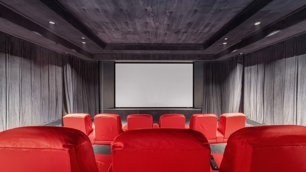 67 Byron Road Weston, MA 02493 - Photo 28 of 42 a projector room with a bed and a chandelier