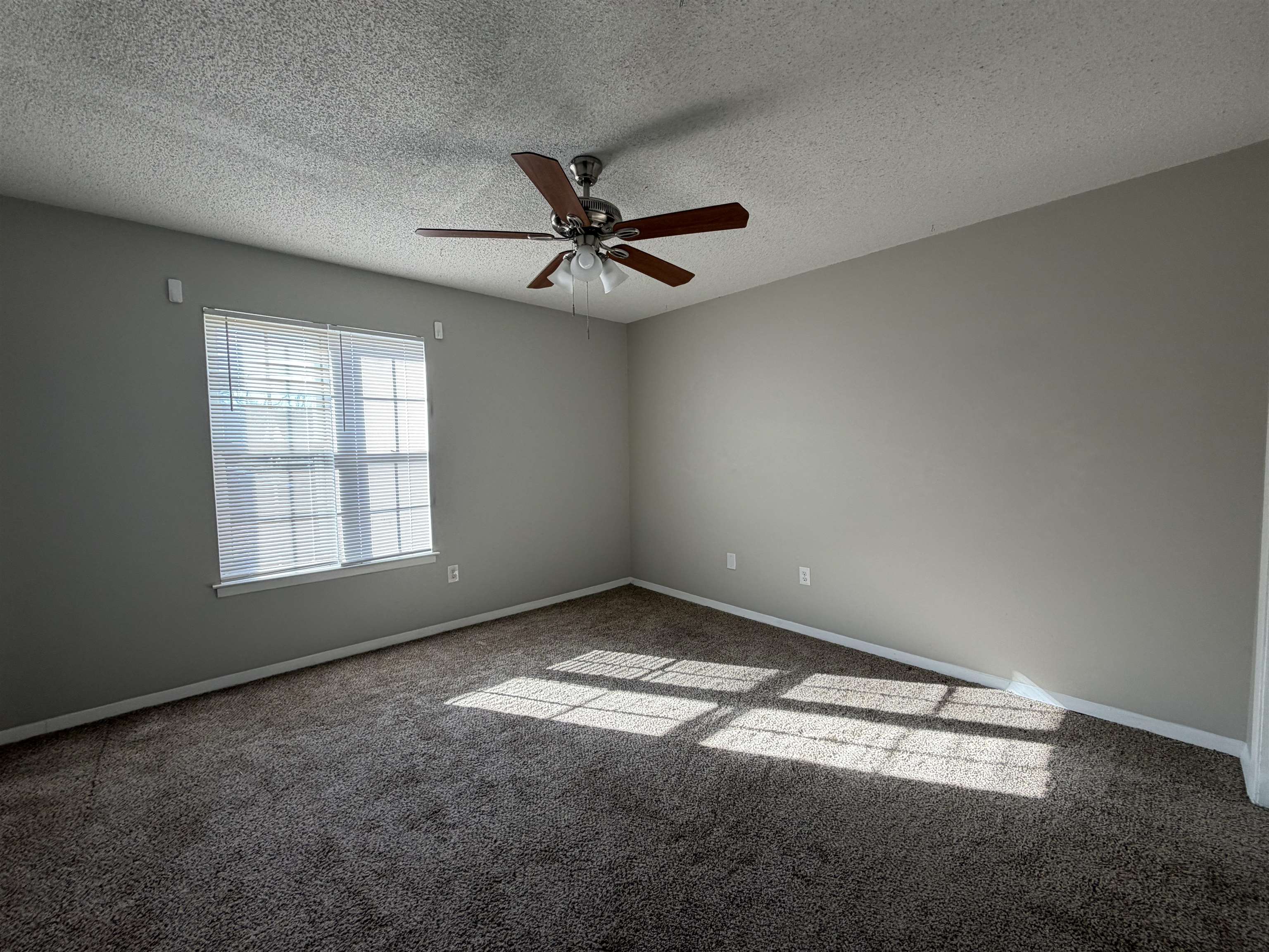 6302 Leamont Drive Millington, TN 38053 - Photo 7 of 11 Carpeted empty room with ceiling fan and a textured ceiling