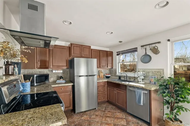 a kitchen with a refrigerator and a stove