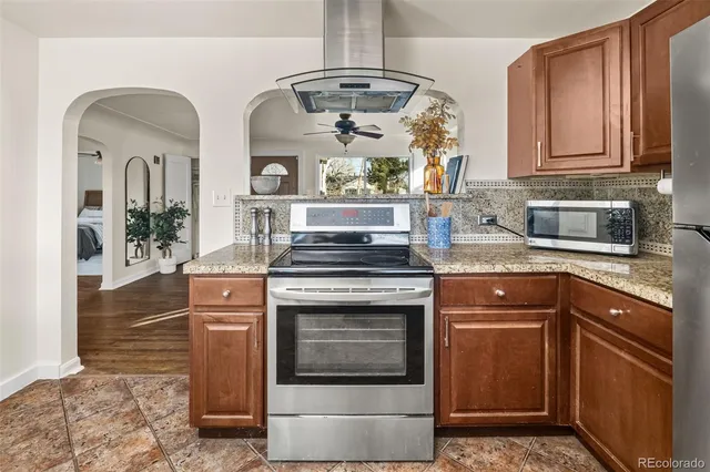 a kitchen with stainless steel appliances granite countertop a stove and a sink