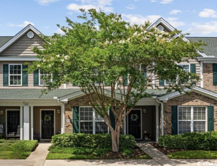 155 Chenoa Drive, Unit E Murrells Inlet, SC 29576 - Photo 1 of 34 Traditional-style home with covered porch, roof with shingles, and brick siding