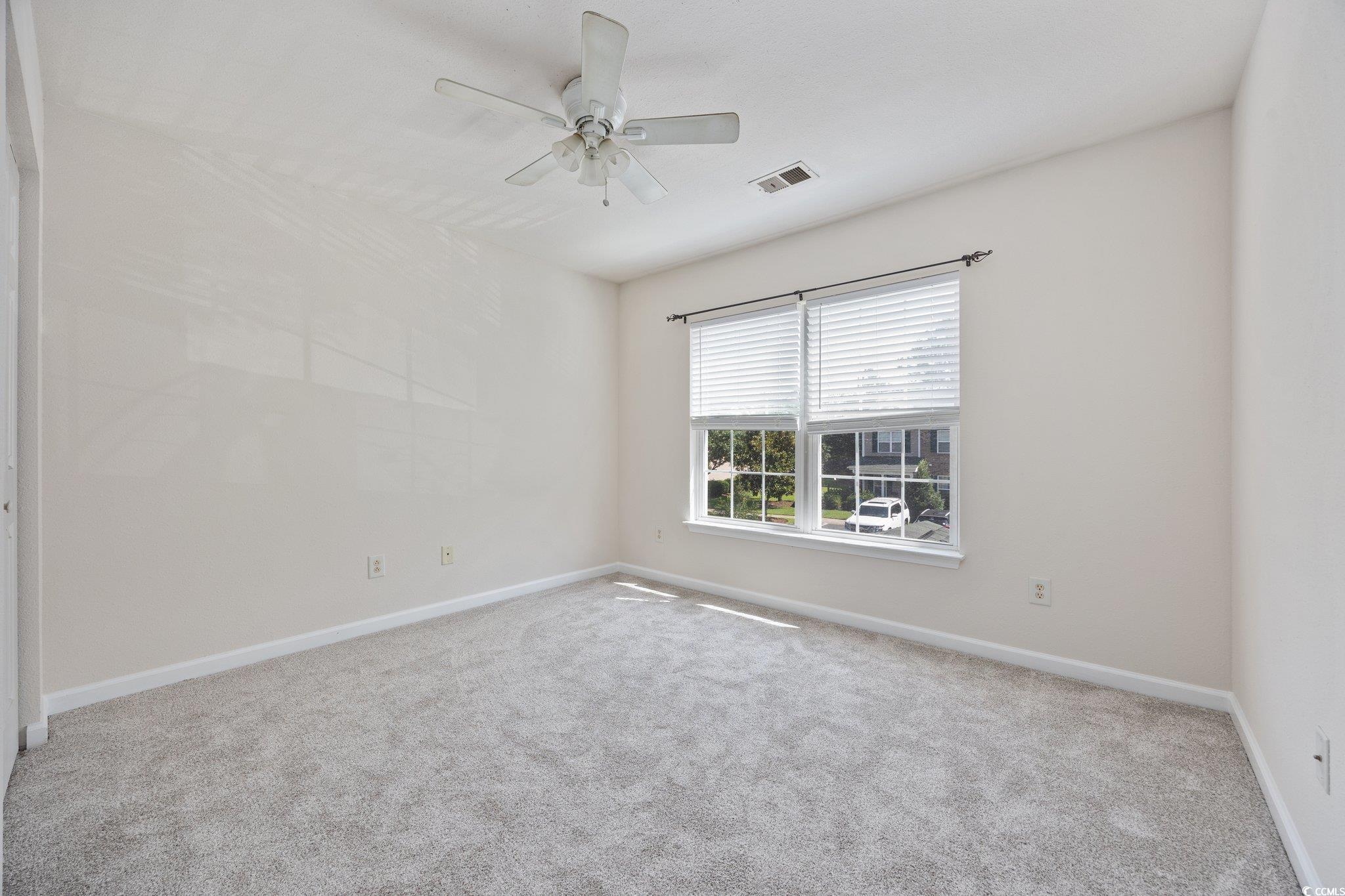 155 Chenoa Drive, Unit E Murrells Inlet, SC 29576 - Photo 12 of 34 Kitchen featuring white microwave, light colored carpet, a chandelier, a breakfast bar area, and hanging light fixtures