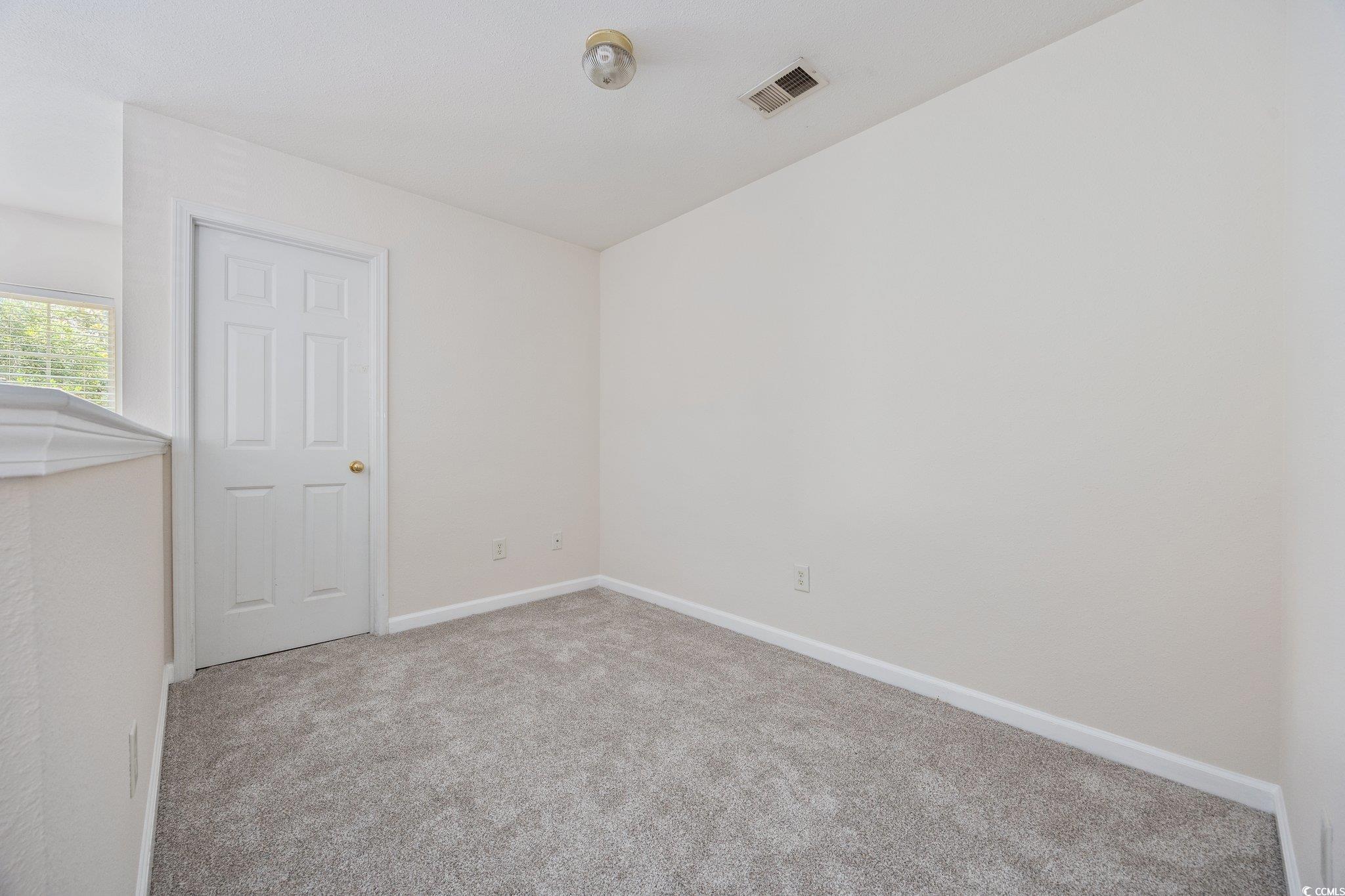 155 Chenoa Drive, Unit E Murrells Inlet, SC 29576 - Photo 15 of 34 Unfurnished bedroom featuring carpet floors, a closet, and ceiling fan