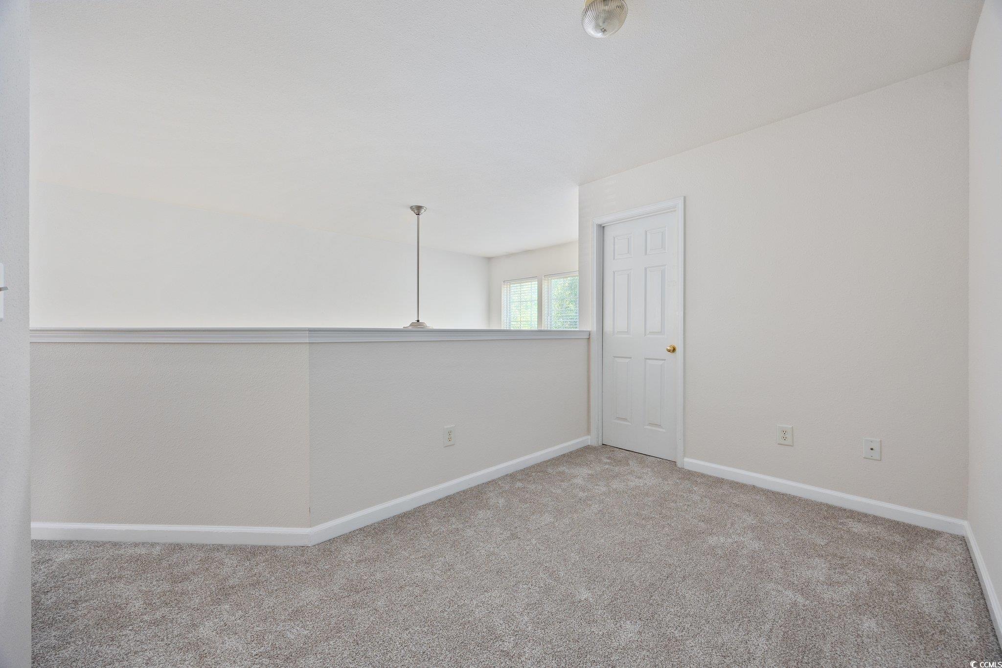 155 Chenoa Drive, Unit E Murrells Inlet, SC 29576 - Photo 17 of 34 Empty room featuring carpet and baseboards