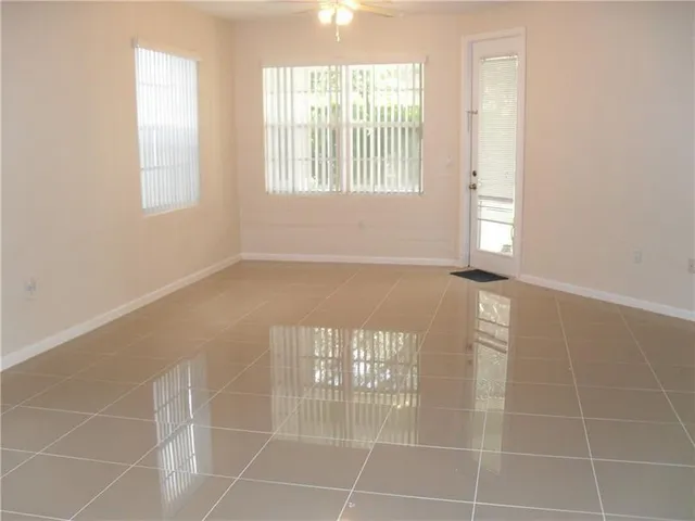 a view of a livingroom with an empty space and a window