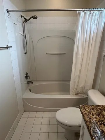 a view of a patio with a table chairs and a swimming pool
