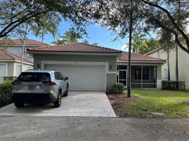 a view of a house with a yard and sitting area